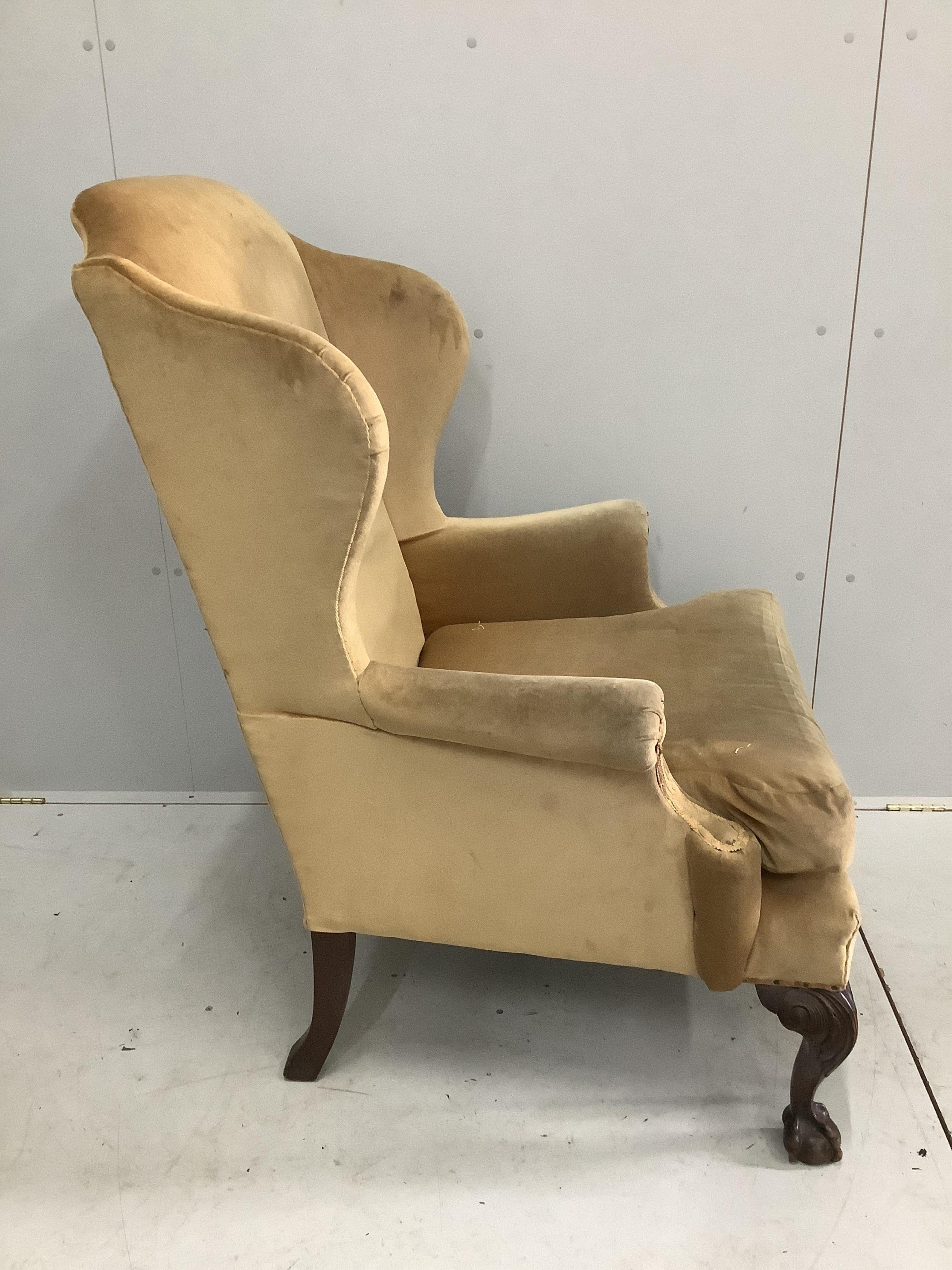 A George III style wing armchair, old gold dralon upholstery, width 82cm, depth 74cm, height 116cm. Condition - fair